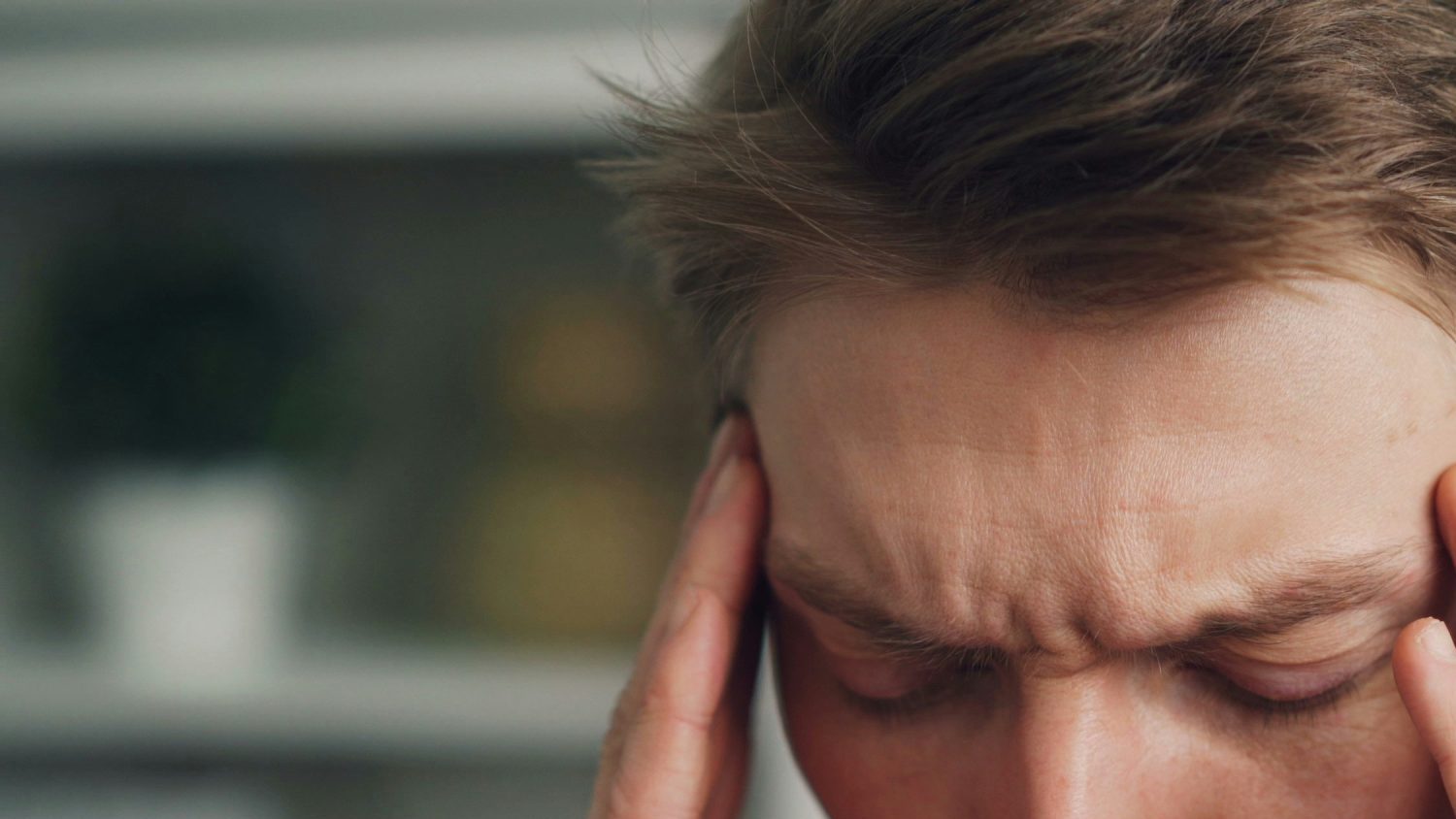 Person experiencing headache symptoms associated with migraine.